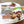 Load image into Gallery viewer, 味付き焼肉の牛カルビが盛り付けられたご飯の皿と、250gの小分けパックが並んでいる画像。ジューシーな牛カルビと白ご飯が特徴で、冷凍庫で3ヶ月保存可能。
