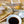 Load image into Gallery viewer, 大トロホルモン焼きの調理シーン。塩味、みそ味、醤油味、スタミナ味の調味料、大豆、にんにく、塩を使った料理の材料が並ぶキッチン風景。

